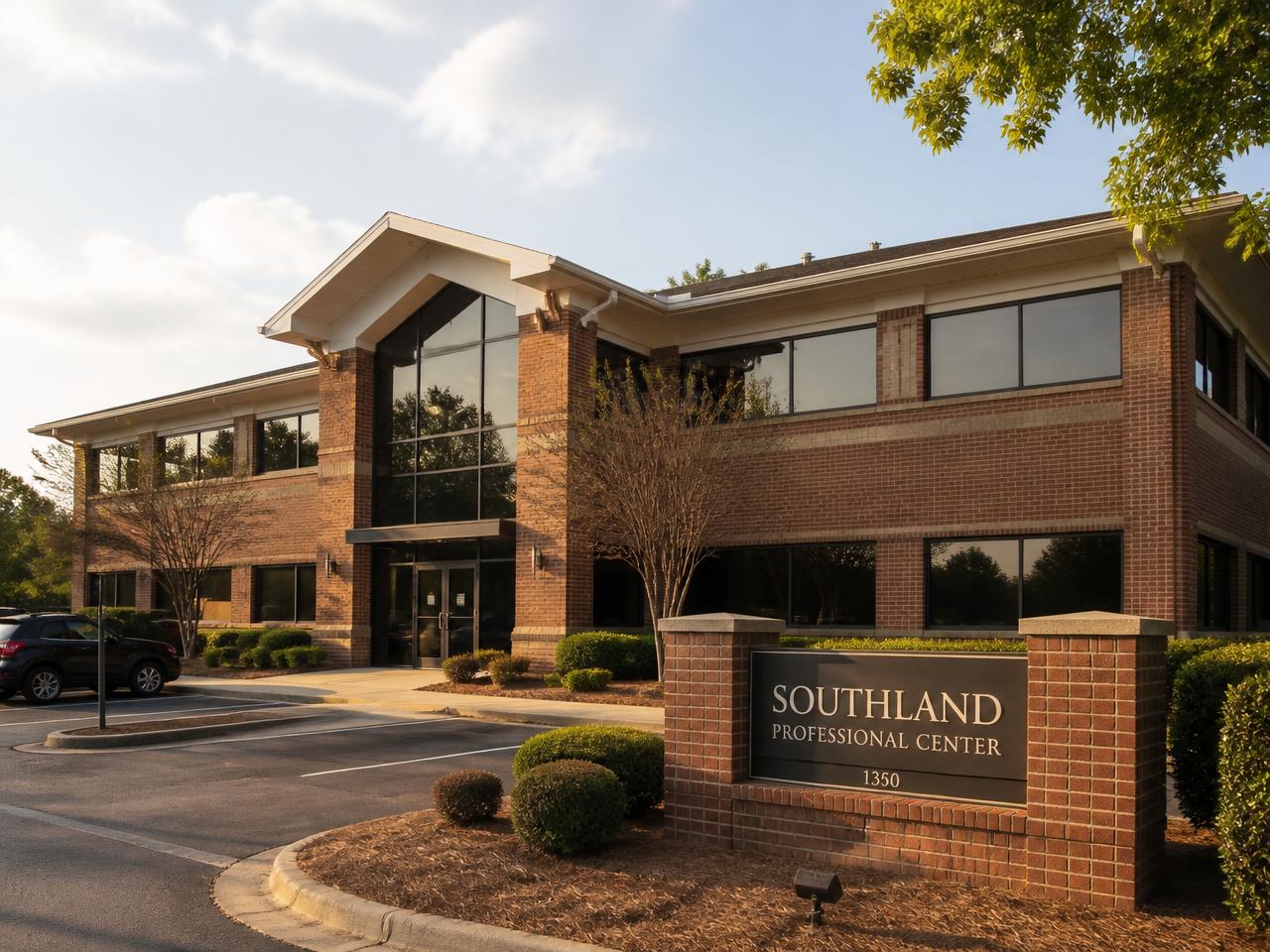 Brick and glass office building exterior with on-site parking, home of Forest Park Offices in Forest Park, Georgia